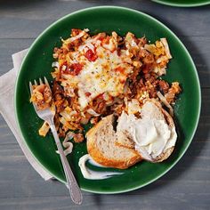 a green plate topped with bread and meat covered in cheese