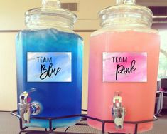 there are two large jars with blue and pink liquid in them, one has a sticker on it