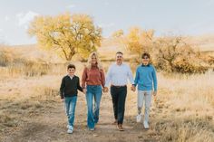 a family walking down a dirt road in the desert