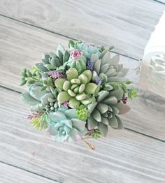 a bouquet of succulents on a wooden table