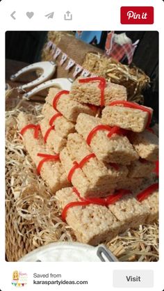 some kind of food that is on a table with straw and red ribbon around it