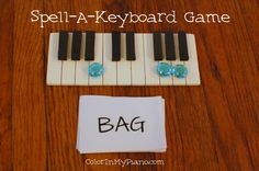 a small keyboard sitting on top of a wooden table next to a note with the word bag