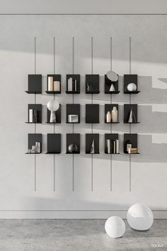 a white room with some black shelves on the wall