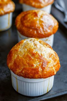 three muffins sitting on top of a baking pan next to another muffin