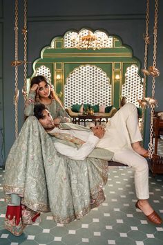 a man and woman sitting on a swing