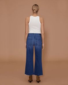 The Weekend jean is the perfect relaxed jean. Sitting low slung under the belly button with a soft bow leg shape and raw hem. The classic faded indigo wash makes it endlessly versatile. Made in Los Angeles Size & Fit • Fits true to size, however those who are between sizes should take a smaller size• Low-slung, cut for a wide-leg fit• Mid weight, supersoft stretch fabric• All sizes have an inseam leg length of 27''• Model is 5'8'' and is wearing a size 26*Rise: 11''• Inseam: 27'' Details & Care Dark Wash Cropped Bottoms With Five Pockets, Relaxed Fit Cropped Bottoms In Dark Wash, Dark Wash Cropped Relaxed Fit Flare Jeans, Dark Wash Cropped Flare Jeans With Relaxed Fit, Cropped Dark Wash Relaxed Fit Flare Jeans, Chic Cropped Dark Wash Bottoms, Dark Wash Cropped Flare Jeans With Five Pockets, Dark Wash Cropped Pants With Five Pockets, Cropped Dark Wash Flare Jeans With Five Pockets