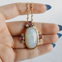 A mesmerizing white iridescent opal set in a luxurious gold pendant with tourmaline and diamond accents. This vintage necklace is one-of-a-kind, with it's shimmering colors and pink accents. Opal Multi-stone Pendant Necklace, Elegant Opal Jewelry With Large Pendant, Elegant Opal Necklace With Large Pendant, Fine Jewelry With Ethiopian Opal And Gemstone Accents, Pink Opal Gemstone Pendant Jewelry, Pink Opal Pendant With Gemstone, Pink Opal Pendant Jewelry, Vs Diamond, Opal Stone