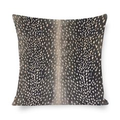 a black and white pillow with an animal print on the front, featuring two different spots