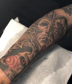 a man's arm with tattoos on it and an image of a woman wearing a mask