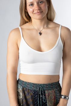 This simple stretchy tank top is a staple for any casual capsule wardrobe. Whether you wear it at the gym for athleisure, the shala as a simple yoga top, or out on the town, it is sure to fit right in. Where will you wear yours? Versatile Everyday Crop Top, Versatile Yoga Tank Top With Built-in Bra, Basic Tank Tops For Yoga, Basic Yoga Tank Tops, Casual Seamless Crop Top For Everyday, Everyday Stretch Crop Top Sports Bra, Casual Crop Top With Built-in Bra For Everyday, Casual Seamless Camisole For Everyday, Casual Camisole Top For Gym