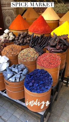 several buckets filled with different types of spices