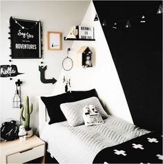 a bedroom with black and white decor on the walls