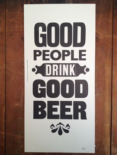 a poster that reads, good people drink good beer on the side of a wooden wall