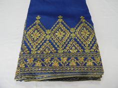 George Fabric/African Silk George Lace Fabric For Wedding Party/Embroidered Bridal Lace Whole Set Of 5 Yards, Royal Blue & Golden Color 1-George Fabric Is Renowned In Africa For Its Brilliant Gold Embroidery And Lush Colors. This Fabric Is 2-Commonly Worn By High Class Or People Of Wealth, And Symbolizes Luxury And Prominence. 3-Condition：Brand New In Good Condition 4-Length：5 Yards As A Piece 5-Color : As Pictures Shows. 6-Occasion: Wedding, Baby Shower, Bridal Shower, Graduation party, Hou Blue Embroidered Fabric For Ceremonial Festive Occasions, Gold Embroidered Dola Silk Fabric For Reception, Embroidered Blue Blouse Piece For Traditional Ceremonies, Gold Dola Silk Embroidered Fabric For Reception, Royal Embroidered Traditional Wear For Festivals, Royal Embroidered Traditional Wear For Festive Occasions, Blue Traditional Wear With Dupatta For Ceremonial Occasion, Blue Embroidered Saree For Traditional Ceremonies, Ceremonial Elegant Blue Saree