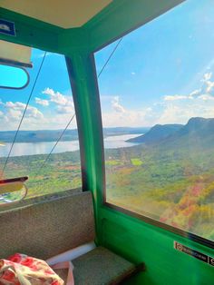 a view from the inside of a bus looking out at mountains and water in the distance