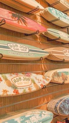 many surfboards are hanging on the wall