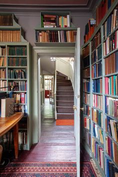 an open door leading to a library filled with books