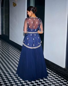 Embrace exquisite elegance in this midnight blue hand-embroidered asymmetric peplum ensemble! Intricately adorned with sequins, stones, and beads, this peplum exudes opulence and charm. The v-neckline and handmade tassels at the sleeves add a touch of sophistication. Paired with a flowy georgette skirt and a matching net dupatta, this ensemble offers a perfect blend of grace and allure. Peplum And Skirt, Georgette Skirt, Net Dupatta, Blue Hand, Midnight Blue, Hand Embroidered, Skirt Set, Tassels, Skirt