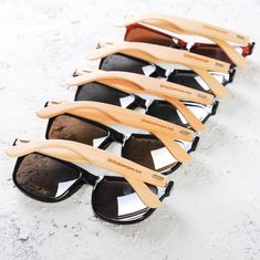 five pairs of wooden sunglasses lined up against each other