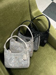 New for SS23. This light grey mini hobo bag, an iconic Prada style, comes in a luxurious satin version studded with crystals and decorated with the emblematic enamel triangle logo. All items are brand new & 100% authentic guaranteed. Supplied in its original packaging. DETAILSAll-over decoration (artificial crystals)Zipper closureEnameled metal triangle logoSilk satin lining17 cm Height6 cm Length22 cm WidthNeed assistance? Use our Sourcery service or speak to a member of our team via WhatsApp Grey Designer Bag, Sparkly Prada Bag, Prada Crystal Bag, Mini Bags Aesthetic, Prada Bag Aesthetic, Sparkly Bag, Mini Hobo Bag, Prada Style, Rhinestone Bag