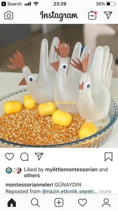 some fake birds are in a bowl filled with yellow eggs and corn on the table