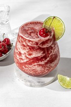 a red drink sitting on top of a white table