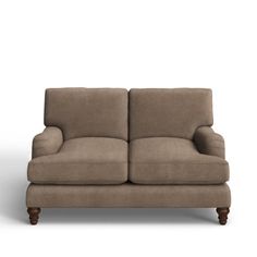 a brown couch sitting on top of a white floor