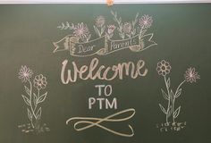 a welcome sign is written on a chalkboard