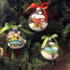 three ornaments hanging from a christmas tree decorated with cartoon characters and words that spell out whoville