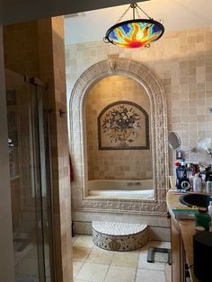 a bath room with a sink and a tub next to a shower head mounted on a wall