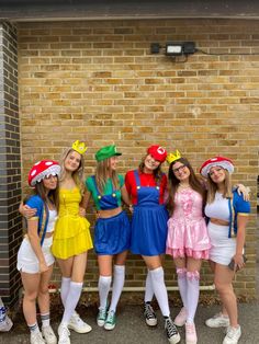 several girls dressed up in costumes posing for the camera