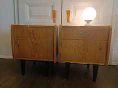 two wooden dressers sitting next to each other on top of a hard wood floor