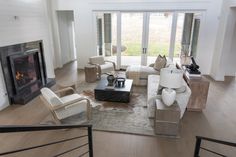 a living room filled with furniture and a fire place in the middle of a room