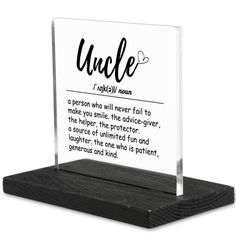 an acrylic plaque on a wooden stand with the words uncle written in black ink