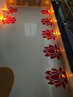 the floor is decorated with red flowers and lit candles on it, along with other decorations