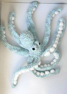 an octopus stuffed animal with white balls on its body and tentacles attached to it's back