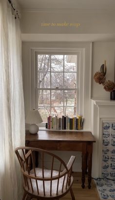 a room with a desk, chair and bookshelf next to a fireplace in it