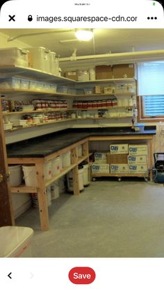 an empty room with shelves and boxes on the floor