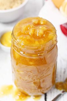 a jar filled with honey sitting on top of a table