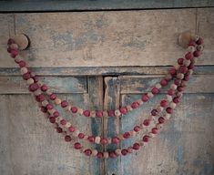 an old wooden door with some beads on it