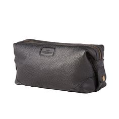 The Lucchese Dopp Kit is a perfect match to the overnight duffle or rolling duffle. An extra-wide zippered opening makes it easy to stash your essentials. Three interior pockets help keep small items organized on the road. A snap closure at both ends doubles as a handle. Functional Black Pouch Travel Bag, Classic Cases With Luggage Sleeve For On-the-go, Rectangular Travel Case With Zipper Closure, Rectangular Travel Cases With Zipper Closure, Black Practical Travel Accessories With Zipper Closure, Zipper Closure Travel Bag Pouch For On-the-go, Black Practical Travel Accessories With Zipper, Leather Travel Cases With Leather Trim, On-the-go Travel Bag With Zipper Closure