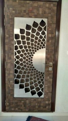 a bathroom door with an artistic design on it