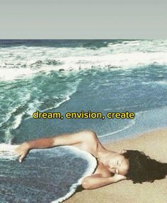 a woman laying on top of a sandy beach next to the ocean with words above her