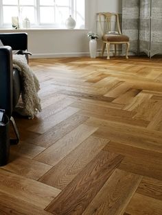 a living room with hard wood floors and white walls