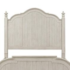 the headboard and foot board of a bed with white wood furniture on top of it