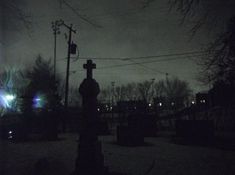 a cemetery at night with the lights on