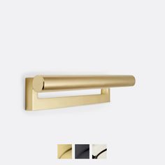 an image of a gold door handle on a white wall with three different colors and sizes