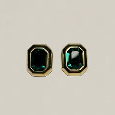 The Vintage Green Rectangle Earrings feature stunning faceted emerald green glass rhinestones and a high polish gold tone metal. Circa 1980s. Note, one rhinestone has a tiny chip. Measure 1" Only one pair available. Ready to ship. Cheap Green Rectangular Earrings, Gold Emerald Rectangular Earrings, Gold Rectangular Emerald Earrings, Gold Emerald-cut Emerald Earrings, Gold Emerald-cut Earrings For May Birthstone, Gold Emerald Cut Emerald Earrings, Gold Emerald Cut Earrings For May Birthstone, Gold Emerald-cut May Birthstone Earrings, Rectangle Earrings