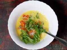 a white bowl filled with soup on top of a table