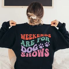 a woman wearing a black sweatshirt with the words weekends are for dogs shows on it